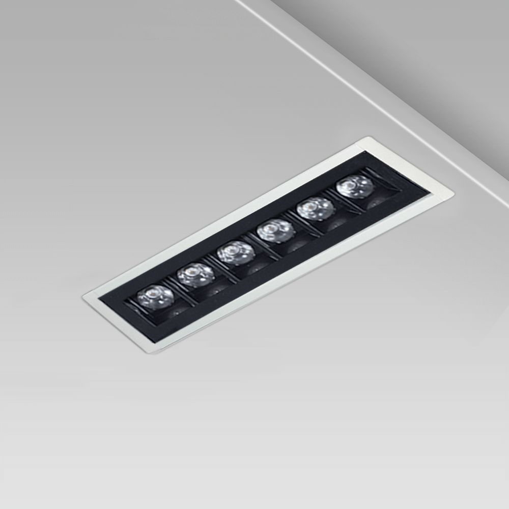 Linear ceiling recessed downlight with a minimalist design for indoor lighting, with protruding frame and UGR<16 black square optic